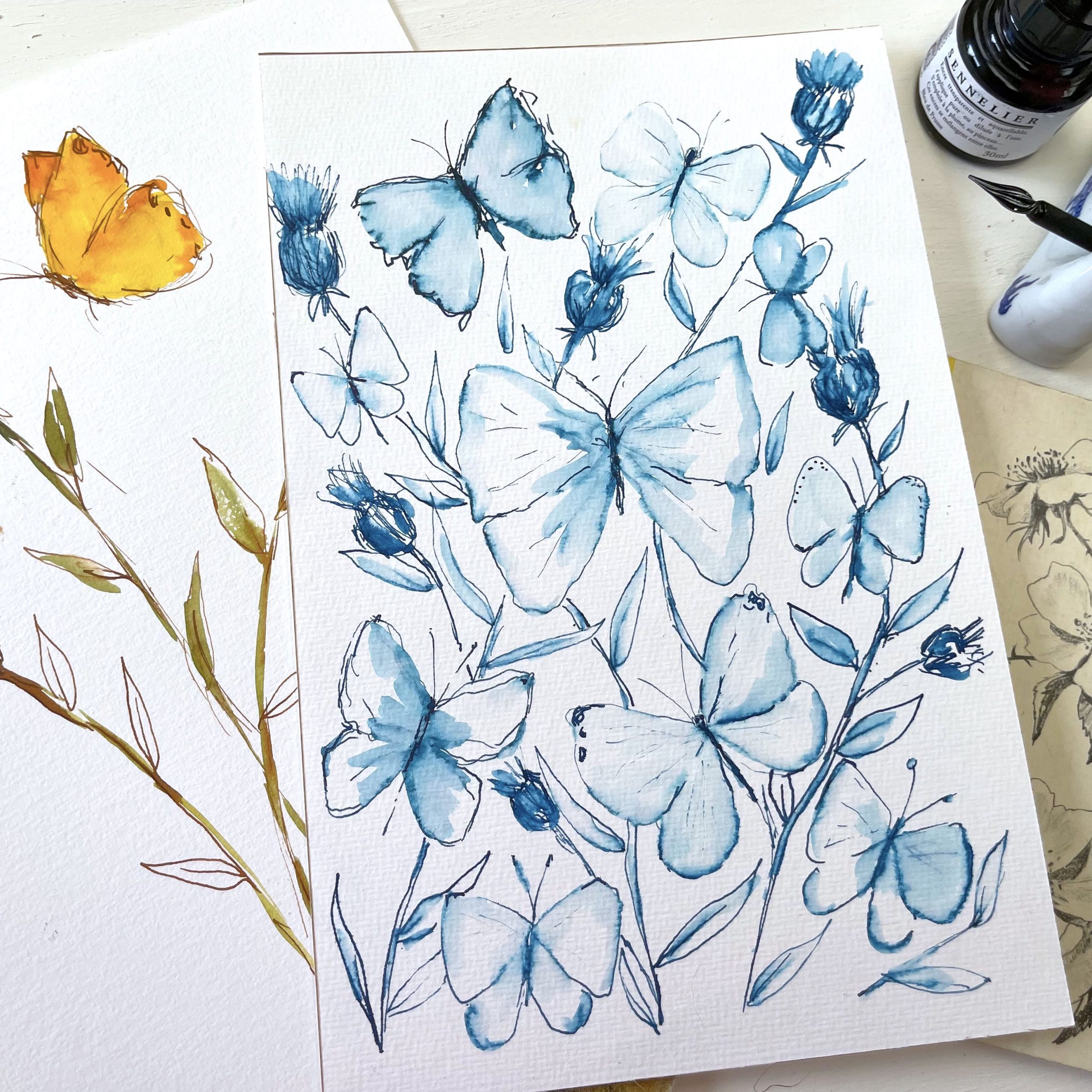 Watercolor painting of blue butterflies with sennelier ink and glass pen